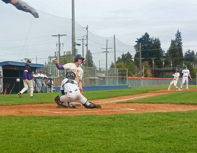 Port Angeles Carson Waddell blocks the plate against North Kitsap but the ball gets away from him and the run scored. Waddell later had a huge play at the plate in the seventh inning to help send the game to extra innings. (Pierre LaBossiere/Peninsula Daily News)