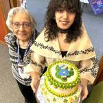 Sage Glover, the Sunbonnet Sue Quilt Clubs youngest member, holds a cake she made for the clubs 40th anniversary party on April 8. She stands by her grandmother Martha Scott, another longtime club member, who purchased the ingredients for the cake. (Matthew Nash/Olympic Peninsula News Group)