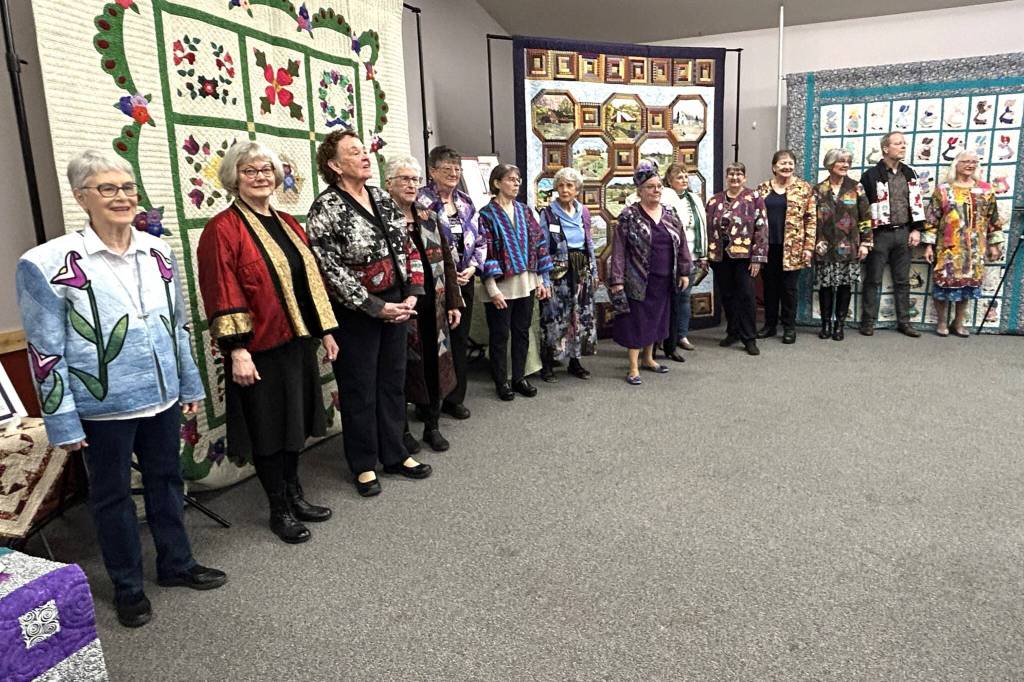 Models for the Wearable Fashion Show during the Sunbonnet Sue Quilt Clubs 40th anniversary stand for a photo at the Sequim Masonic Lodge after they walked through the crowd and showed off their outfits. (Matthew Nash/Olympic Peninsula News Group)