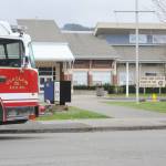 A fire engine sits along Spartan Avenue in front of Forks High School during an investigation on Wednesday of a shooting threat on campus. (Lonnie Archibald/for Peninsula Daily News)