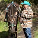 Long time BCH member Kandy Mulrooney holds Sam for Stephanie Baker, who stepped off to grab some refreshments for both horse and rider at the groups cowboy kitchen.  (Judy Dupree)