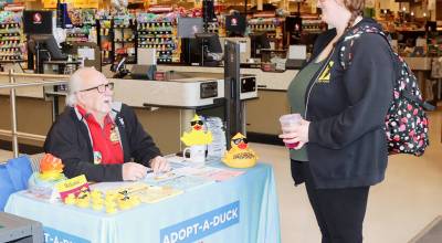 Larry Strohm, a volunteer for the Olympic Medical Center Foundation, explains the Great Olympic Peninsula Duck Derby to Kati Carlson-Underhill of Port Angeles at the Lincoln Street Safeway in Port Angeles. Ducks are selling for $7 for the derby, which will be the 37th running as a fundraiser for the OMC Foundation on May 17. Ducks are on sale at all Safeways in Port Angeles and Sequim, in addition to Swains and Walmart on the weekends. (Dave Logan/for Peninsula Daily News)