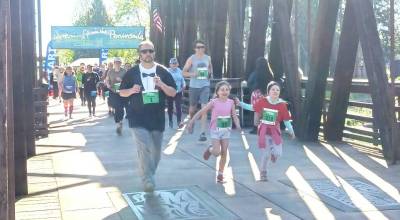 One of the dozen or so staggered starts at the Sequim Railroad Bridge run. Staggered starts were used to limit the number of people on the bridge all at once. (Pierre LaBossiere/Peninsula Daily News)