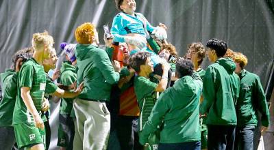 Port Angeles goalkeeper Maverick Williams is lifted up by his teammates during the teams celebration after Williams stopped two penalty kicks in a 3-2 (4-3 PKs) win over North Kitsap. (Jay Cline/for Peninsula Daily News)