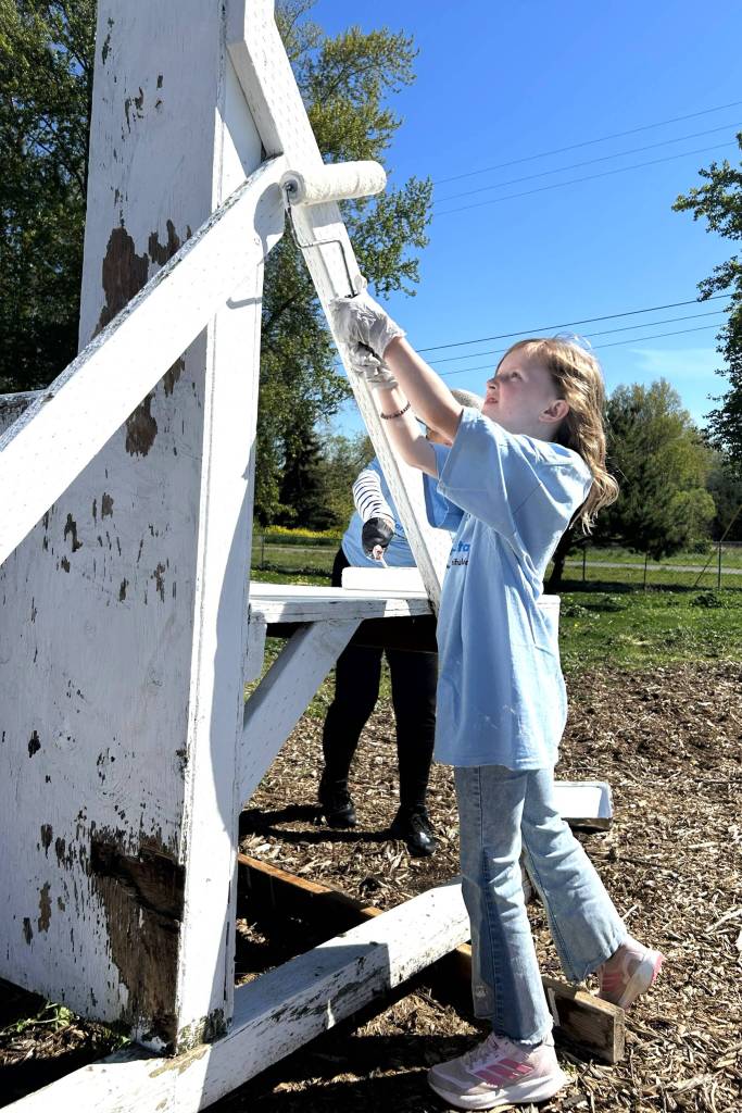 Myka Stewart, 9, paints a portion of the Sequim Police Departments dog agility course at Carrie Blake Community Park on April 25. She and her mom Nikki of Sequim Community Church wanted to help fellow church volunteers for Sequim Beautiful Day. (Matthew Nash/Olympic Peninsula News Group)