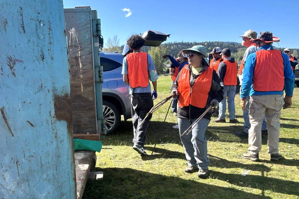Paula Huls, a volunteer with Habitat for Humanity of Clallam County, helps load a dumpster during the Rally in the Alley event on April 25 at Carrie Blake Community Park. She said it was her second time helping and she wanted to give back and help people with spring cleaning. (Matthew Nash/Olympic Peninsula News Group)