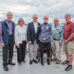 Celebrants at Sequim Bay Yacht Clubs 50th anniversary dinner at John Wayne Marina include, from left, Rudy Hessels, historian Jean Hessels-Petit, longest-tenured members Bob and Kelly Macaulay, oldest member Chris Coolures and Dennis Miller, who was essential in getting the rowing program added to the club 10 years ago. (Emily Matthiessen/for Olympic Peninsula News Group)