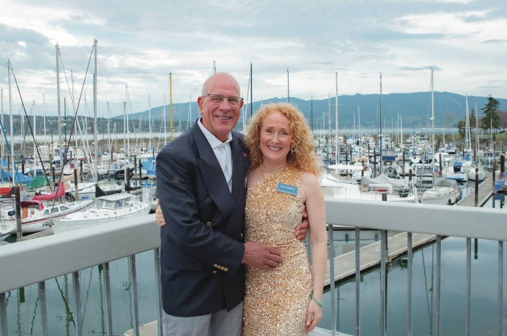 Newlyweds Joel Cziok and Jenn Gibbings pause for a photo at John Wayne Marina amid the Sequim Bay Yacht Clubs 50th anniversary celebration. (Emily Matthiessen/for Olympic Peninsula News Group)