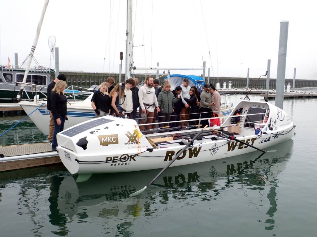The Row West team and their families pray before beginning the voyage to Hawaii. (Pat Neal/For Peninsula Daily News)