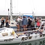 The Row West Team and their families share goodbye hugs. (Pat Neal/For Peninsula Daily News)