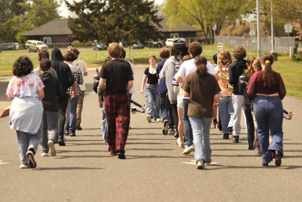 Emma Reich, drum major for Sequim Middle School, leads the schools band in the parking lot as they ready for the Sequim Irrigation Festivals Grand Parade on Saturday. Band director George Rodes said the middle school and Sequim High School bands will join together for the performance. The bands are one of more than 100 entries in the parade, which will begin at noon and go from Dunlap Avenue to right before Seventh Avenue along West Washington Street. (Matthew Nash/Olympic Peninsula News Group)
