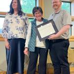 Frances Howell accepts a Clallam County Community Service award on Wednesday from Regional Publisher Eran Kennedy, left, and Peninsula Daily News Editor Brian McLean at the Port Angeles Senior & Community Center. (Cynthia Evans)