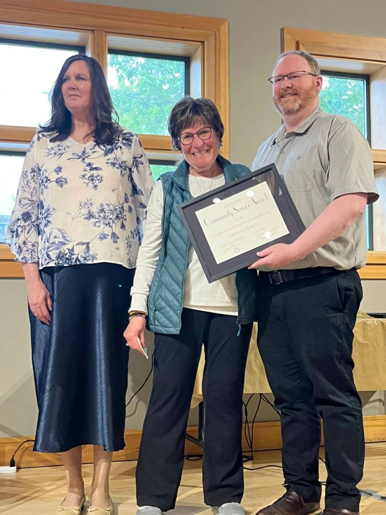 Frances Howell accepts a Clallam County Community Service award on Wednesday from Regional Publisher Eran Kennedy, left, and Peninsula Daily News Editor Brian McLean at the Port Angeles Senior & Community Center. (Cynthia Evans)