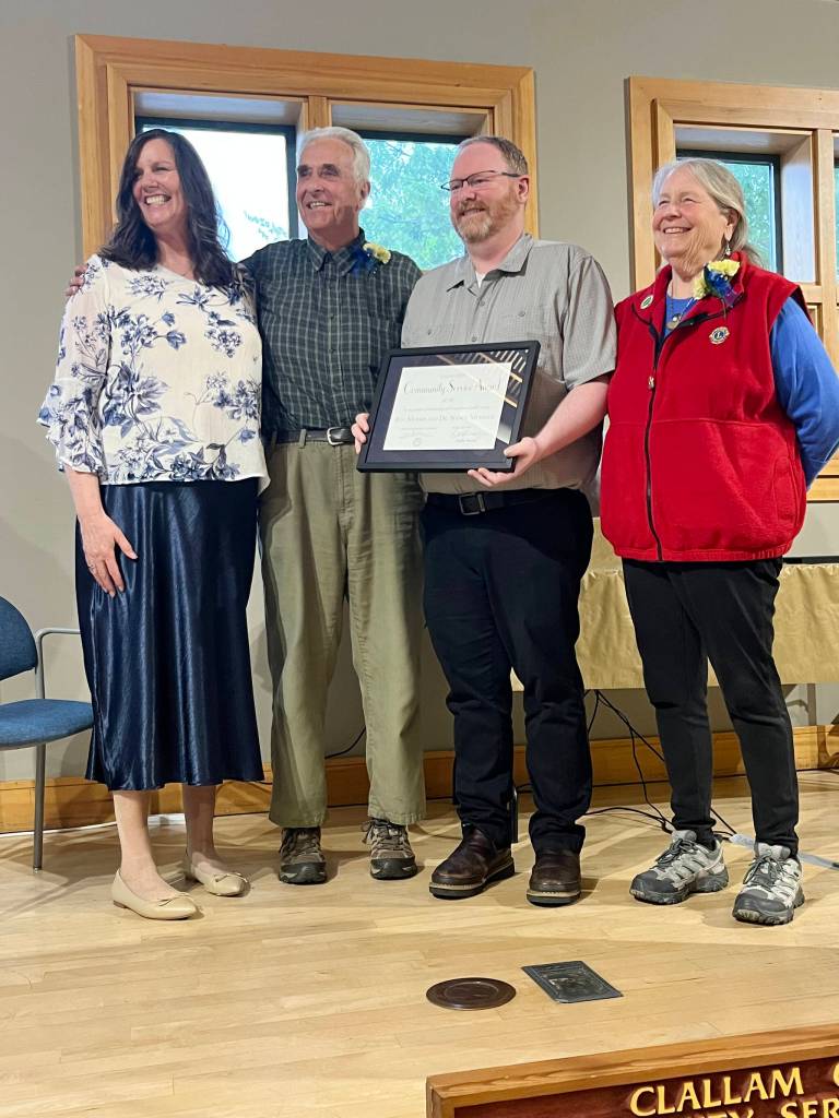 Roy Morris and Dr. Nancy Messmer accept a Clallam County Community Service award on Wednesday as presented by Regional Publisher Eran Kennedy, left, and Peninsula Daily News Editor Brian McLean, second from right, at the Port Angeles Senior & Community Center. (Cynthia Evans)