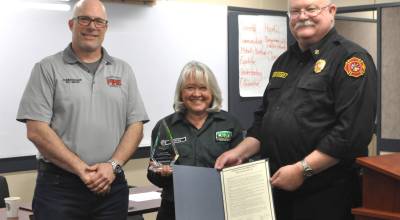 Donna Stoffel received a state Volunteer Service Award in the Peninsula/Coastal region for her hours of service, including organizing the Safety Fair. She was recognized last month by Clallam County Fire District 3 commissioners and staff, including board chairman Bill Miano, left, and Fire Chief Justin Grider. (Matthew Nash/Olympic Peninsula News Group)