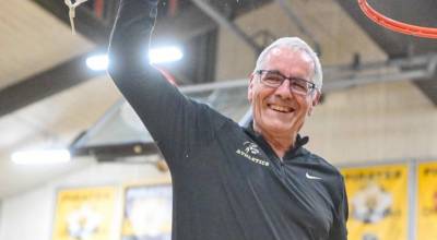 Rick Ross, Peninsula College Dean of Athletics and Student Activities, is retiring June 20 after 32 years at the school. He was invited to cut down the net the womens basketball North Region championship night. (Jay Cline/Peninsula College)