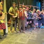 Ms. Pennywise (Angela Poynter), left, manages the line for Public Amenity No. 9 in Olympic Theatre Arts production of Urinetown the Musical. Actors next to Poynter, from left, include Hayden Pomeroy as Bobby Strong, Joel Swenning as Old Man Strong, Marni Whitehead as Josephine Strong, August Maberry as Tiny Tom, Claire Wegner as Robby the Stockfish, Matt Forrest as Hot Blades Harry, Gretel Maberry as Billy Boy Bill, Susan Cates as Becky Two Shoes, Shoshanna Feist as Soupy Sue and Diane Smith as Little Sally. (Matthew Nash/Olympic Peninsula News Group)
