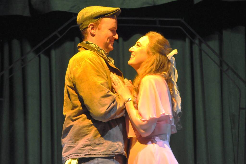 Hayden Pomeroy and Sunshine Peterson, as Bobby and Hope, embrace during a musical number in Urinetown the Musical. (Matthew Nash/Olympic Peninsula News Group)