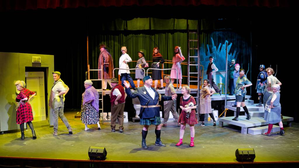 The full company of Olympic Theatre Arts production of Urinetown the Musical practices the title song Urinetown during a dress rehearsal. (Mark Klinke)
