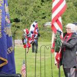Betsy Schultz, representing the Captain Joseph House, is one of several people laying wreaths during the Memorial Day ceremony at Mount Angeles Memorial Park. The agenda had patriotic music, a Memorial Day address by Commander Dave Yarnchak, a three-shot rifle volley, echoing taps and a bagpiper who played Amazing Grace to close the ceremony. (Dave Logan/for Peninsula Daily News)