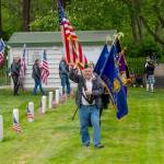 David Harrah of the American Legion Marvin G. Shields Memorial Post 26 in Port Townsend carries the American flag and leads a color guard during a Memorial Day observance at Fort Worden Military Cemetery on Monday. (Steve Mullensky/for Peninsula Daily News)