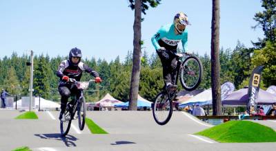 Picture 21-25 Cruiser Class- Caleb Plummer of Port Orchard and Angel Plata of Seattle race in Saturdays BMX 21-25 cruiser class state qualifier at the Lincoln Park BMX track in Port Angeles. A total of 124 riders battled high winds Friday night in 35 motos at Lincoln Park with 374 riders competing in 83 motos in Saturdays state qualifier. All qualifiers will return to Port Angeles on Sept. 27 as the Lincoln Park BMX again hosts the state finals. (Revolution Racing photo)