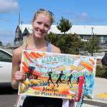 The womens winner of the North Olympic Discovery Marathon Rissa Eilmes of Bremerton with her first-place poster. (Dave Logan/for Peninsula Daily News)