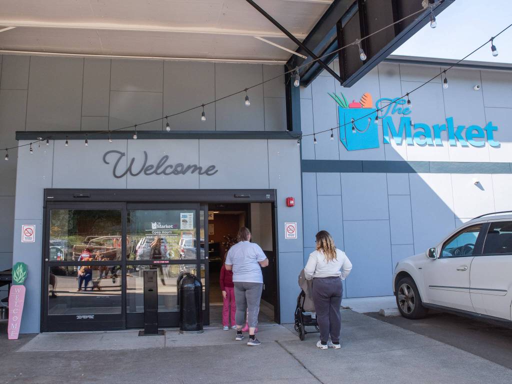 Emily Mathiessen/Olympic Peninsula News Group
Doors open on a weekday to allow waiting clients of the Port Angeles Food Bank.
