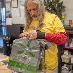 Volunteer Paul Stehr-Green prepares plastic bags for food bank clients. (Emily Mathiessen/Olympic Peninsula News Group)