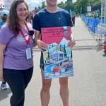 Jack Weaver of Bremerton won the mens 10K and is presented with his poster by Kaitlin Alderson. (Pierre LaBossiere/Peninsula Daily News)