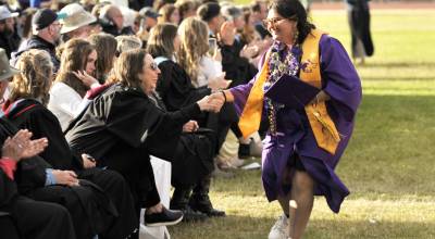 Sequim High School senior Anjaliden Wolfley shakes teacher Julie Rombergs hand as she walks down the front row to receive her diploma on June 5. (Matthew Nash/Olympic Peninsula News Group)