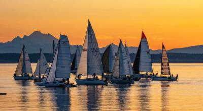Some of the 70 entrants in the 10th Race 2 Alaska sail out of Port Townsend Bay, passing Mount Baker as they head to Victoria, B.C., for the first leg of the 750 mile race to Ketchikan, Alaska, at the 5 a.m. starting gun. The racers have 72 hours to make their way to Victoria, B.C., before a restart at noon on Thursday to complete the remaining 710 miles to Ketchikan. The rules of the race are that your boat cant have an engine, no pre-positioning of supplies and no set course. Any rescue would be hours away. (Steve Mullensky/for Peninsula Daily News)