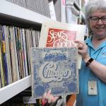 Matthew Nash/Olympic Peninsula News Group 
Tama Bankston, KSQMs administrative director, shows off some of the many records the radio station has on file.