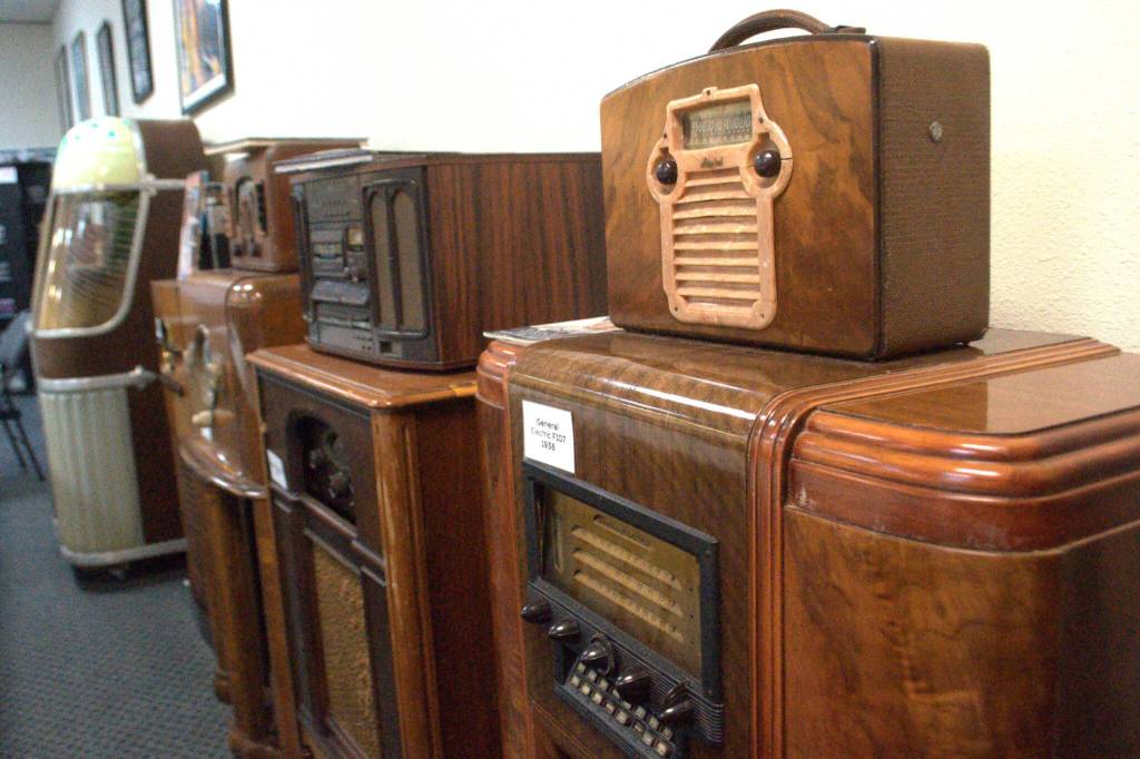 Classic radios line the walls of KSQM 91.5 FMs meeting space. (Matthew Nash/Olympic Peninsula News Group)