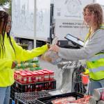 Emily Matthiessen/Olympic Peninsula News Group
Sequim Food Bank volunteer Skylar Kryzworz, who graduated from Sequim High School last year and continues to volunteer when she comes home from college, hands a plastic bag full of food items to teen volunteer Trinity McNorris.