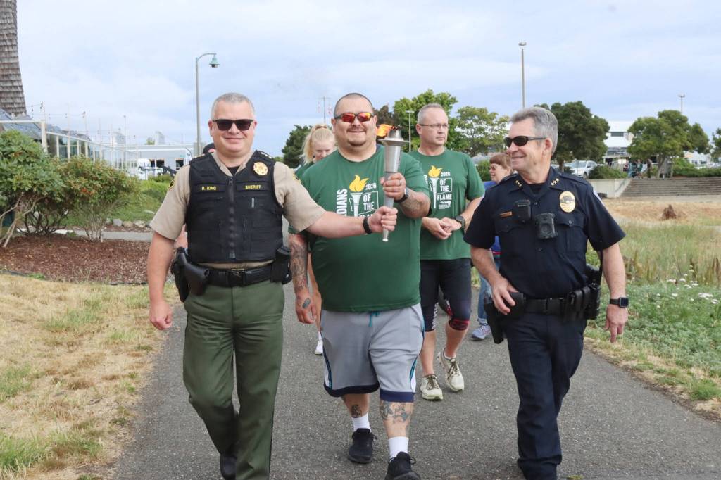 From left, Clallam County Sheriff Brian King, Jimmy Thompson, an officer for the Lower Elwha Klallam Tribe, Clallam County Corrections Deputy Don Wenzl and Port Angeles Chief of Police Brian Smith walk the Olympic Discovery Trail on Friday