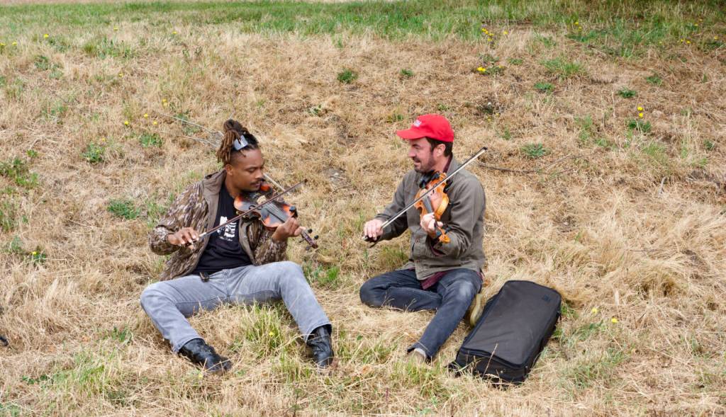 Drake LeBlanc, left, from Lafayette, La., gets a one-on-one lesson from Fiddle Tunes faculty instructor Joel Savoy, from Eunice, La., during a lunch break on Tuesday at the Commons at Fort Worden State Park. This marks the 50th gathering of