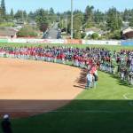 More than 500 young baseball players from all around the Pacific Northwest take part in the Cal Ripken and Babe Ruth opening ceremonies at Civic Field on Wednesday night before the Port Angeles Lefties game. (Dave Logan/for Peninsula Daily News)