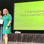 Skylar Krzyworz of Sequim receives a Gold Award, Girl Scouts highest achievement, on June 7 in Federal Way from CEO Andrea Anderson of Girl Scouts of Western Washington. (Heidi Krzyworz)