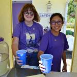 Tilly Lundstrom, left, who now goes by Meadow, and Ali Edgecombe serve lavender lemonade at Nelsons Duckpond & Lavender Farm in 2019 with sales benefiting the Sequim Food Bank. Nelsons Duckpond has been part of the Sequim Lavender Festival since its inception 30 years ago. Lundstrom, now in college, donated proceeds from her sales for years to area nonprofits. (Matthew Nash/Olympic Peninsula News Group file)