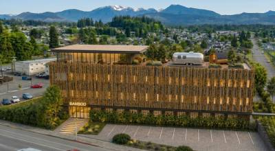 A rendering of the proposed Bamboo Hotel at 1016 E. First St. in Port Angeles shows the four-story building which will feature a fourth-floor lobby, bar, fitness studio, and 3,500-square-foot rooftop terrace with a sauna, hot tub, cold plunge and yoga pavilion. The rendering also shows an Airstream which would be operated by a local vendor to provide food and beverages to guests. (Bamboo Hotel)