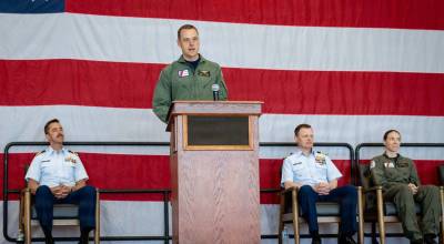 Cmdr. Beau C. Belanger, the incoming commanding officer at Coast Guard Air Station Port Angeles, speaks after the official in-air change of command ceremony on July 9. Belanger assumes command after returning from the U.S. Army War College and previously served as the engineering officer at Coast Guard Air Station Borinquen, Puerto Rico. (Daylan M. Garlic-Jackson/U.S. Coast Guard)