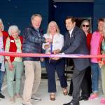 Cutting the ribbon, from left, are Randy Johnson, Clallam County Commissioner; Wendy Sisk, Chief Executive Officer of Peninsula Behavioral Health; and Nathan West, City Manager of Port Angeles, surrounded by representatives from the Sequim and Port Angeles chambers of commerce. An open house of the new facility followed. (Dave Logan/for Peninsula Daily News)