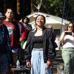 Cheyenne Wheeler announces the name her grandfather, Frank Charles, left, chose for one of the canoes Thursday at the NatureBridge Campus. (Emily Hanson/Peninsula Daily News)