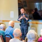 Sequim Police Officer Roderic Sisk was part of a three-person law enforcement panel that advised seniors at The Lodge about red flags that indicate a scam. (Tom Buscher/Olympic Peninsula News Group)