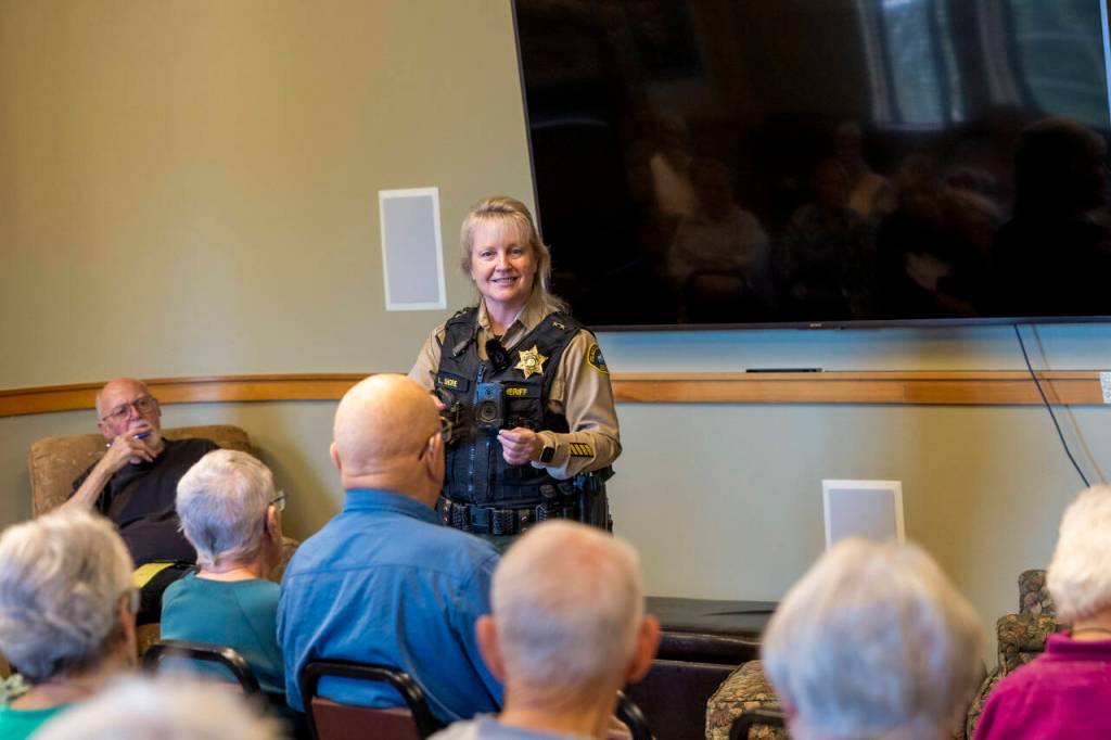 Sequim Police Officer Roderic Sisk was part of a three-person law enforcement panel that advised seniors at The Lodge about red flags that indicate a scam. (Tom Buscher/Olympic Peninsula News Group)