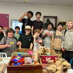 Middle school students who are members of the Sequim YMCA gather around food generously donated to them by the Sequim Food Bank. (Olympic Peninsula YMCA)
